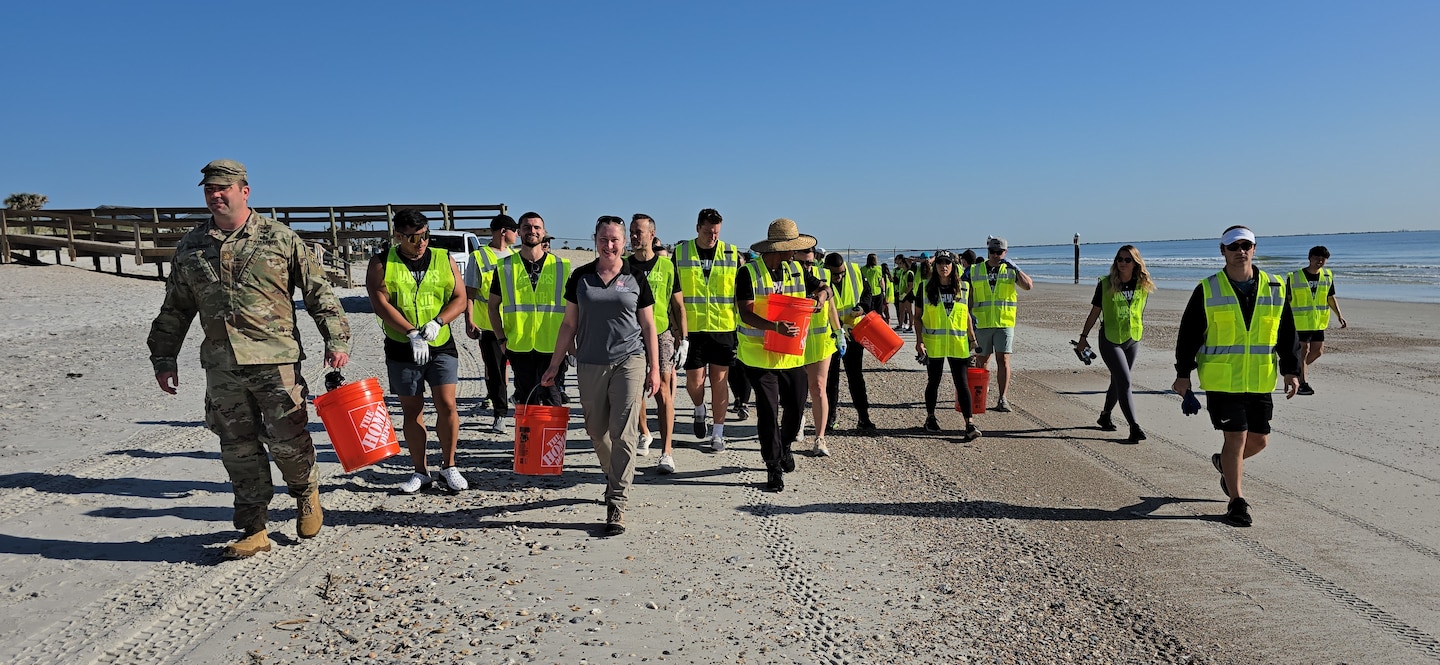 U.S. Army Corps of Engineers, Jacksonville District Deputy Commander, Maj. Matt Westcott leads a team of volunteers from the Jacksonville Jaguars front office to plant bitter panic grass and sea oats along the Duval County Shoreline, near Hanna Park.