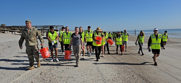 U.S. Army Corps of Engineers, Jacksonville District Deputy Commander, Maj. Matt Westcott leads a team of volunteers from the Jacksonville Jaguars front office to plant bitter panic grass and sea oats along the Duval County Shoreline, near Hanna Park.