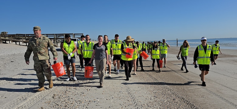 U.S. Army Corps of Engineers, Jacksonville District Deputy Commander, Maj. Matt Westcott leads a team of volunteers from the Jacksonville Jaguars front office to plant bitter panic grass and sea oats along the Duval County Shoreline, near Hanna Park.