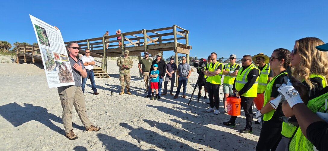 U.S. Army Corps of Engineers, Jacksonville District Invasive Species Biologist, Jessica Spencer explains how removing invasive kalanchoe or “mother of millions” from dunes improves the potential for beneficial vegetation to grow, to volunteers from the Jacksonville Jaguars front office.