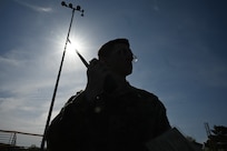 U.S. Space Force Spc. Beckham Taylor, Space Force Honor Guardsman, simulates a radio call-in to the base defense operations center during a training exercise on handling unexploded ordinance on Joint Base Anacostia-Bolling, Washington D.C., April 19, 2025. The event was a part of the First Term Enlisted Course which focused on testing endurance and unit cohesion and hands-on experience. (U.S. Air Force photo by Airman 1st Class Shanel Toussaint)