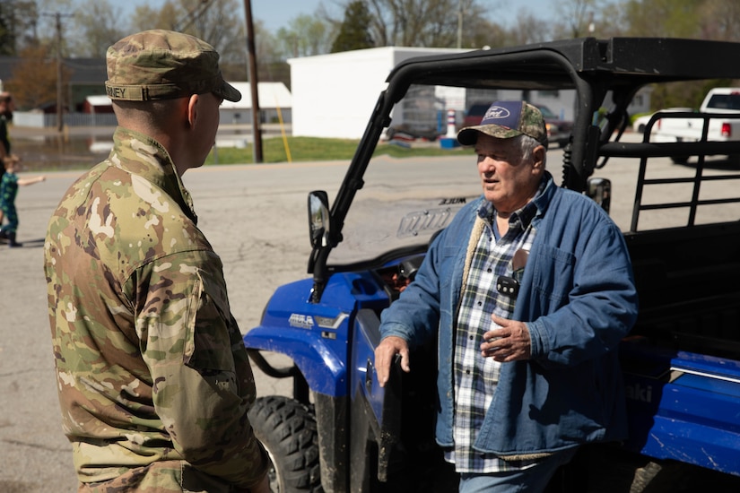 Spc. Austin Briney talks with Boston, Ky. resident Steve Robinson, Apr. 7, 2025. Soldiers with Charlie Battery, 2nd Battalion, 138th Field Artillery Brigade based in Bardstown, work with local officials to aid Nelson Countians stranded because of flood waters. The catastrophic flooding is the result of several days of heavy rainfall across the commonwealth. (U.S. Army National Guard Photo by Milt Spalding)