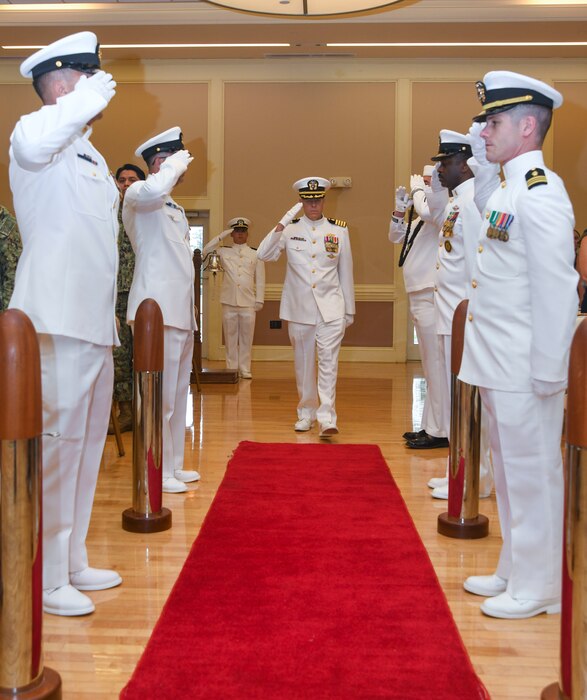 Capt. Martin Braud, EMF-Kilo executive officer, is saluted by side boys during his arrival to the Expeditionary Medical Facility Kilo change of command ceremony at Marston Pavillion, on May 9, 2025. EMF-Kilo is the readiness platform attached to Navy Medicine Readiness and Training Command Camp Lejeune and is comprised of approximately 400 personnel ready to deploy field hospital capabilities during humanitarian or combat mission.
