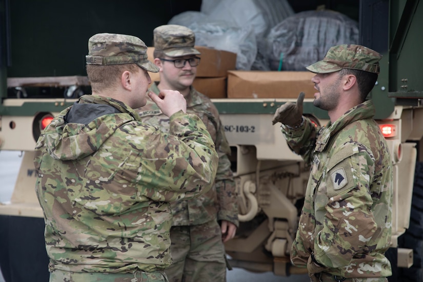 Staff Sgt. James Hamilton talks with Sgt. Michael Daniele and Sgt. Dalton McGuire before the team leaves to assist residents and emergency personnel in Boston, Ky., Apr. 5, 2025. Soldiers with Charlie Battery, 2nd Battalion, 138th Field Artillery Brigade based in Bardstown, work with local officials to aid Nelson Countians stranded because of flood waters. The catastrophic flooding is the result of several days of heavy rainfall across the commonwealth. (U.S. Army National Guard Photo by Milt Spalding)