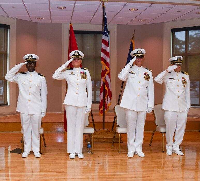 Officers of the official party hand salute while the national anthem plays during his arrival to the Expeditionary Medical Facility Kilo change of command ceremony at Marston Pavillion, on May 9, 2025. EMF-Kilo is the readiness platform attached to Navy Medicine Readiness and Training Command Camp Lejeune and is comprised of approximately 400 personnel ready to deploy field hospital capabilities during humanitarian or combat mission.