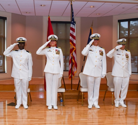 Officers of the official party hand salute while the national anthem plays during his arrival to the Expeditionary Medical Facility Kilo change of command ceremony at Marston Pavillion, on May 9, 2025. EMF-Kilo is the readiness platform attached to Navy Medicine Readiness and Training Command Camp Lejeune and is comprised of approximately 400 personnel ready to deploy field hospital capabilities during humanitarian or combat mission.