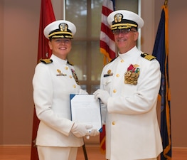 Capt. Anja Dabelic, left, NMCCL commanding officer, poses for an awards photo with Capt. Darryl Arfsten, EMF-Kilo commanding officer, during the Expeditionary Medical Facility Kilo change of command ceremony at Marston Pavillion, on May 9, 2025. EMF-Kilo is the readiness platform attached to Navy Medicine Readiness and Training Command Camp Lejeune and is comprised of approximately 400 personnel ready to deploy field hospital capabilities during humanitarian or combat mission.