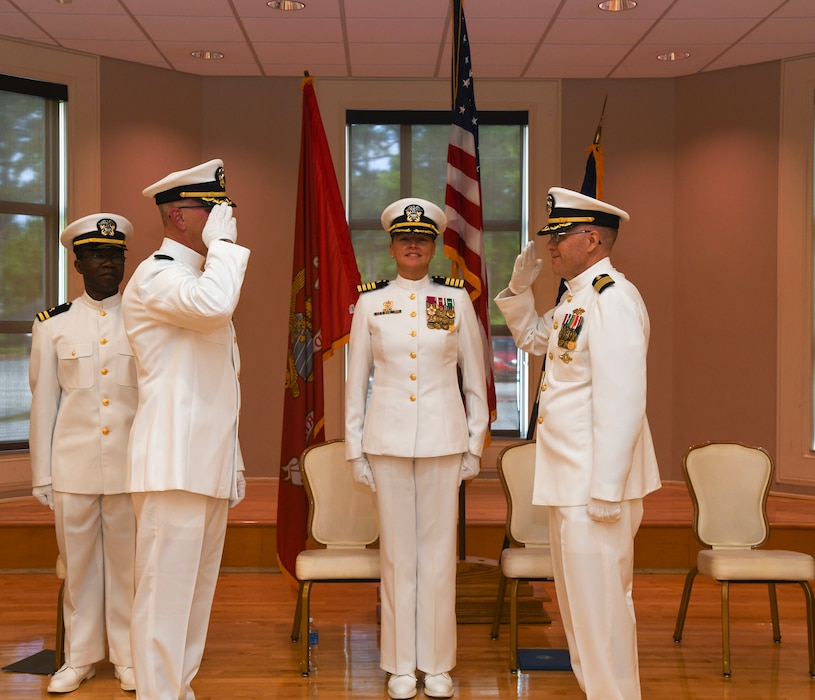 Capt. Darryl Arfsten, left, salutes Capt. Martin Braud, right, infront of Capt. Anja Dabelic, center, while exchanging commanding authority during the Expeditionary Medical Facility Kilo change of command ceremony at Marston Pavillion, on May 9, 2025. EMF-Kilo is the readiness platform attached to Navy Medicine Readiness and Training Command Camp Lejeune and is comprised of approximately 400 personnel ready to deploy field hospital capabilities during humanitarian or combat mission.