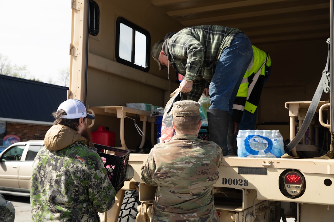 Sgt. Dalton McGuire unloads supplies to help the residents of Boston, Ky., Apr. 7, 2025. Soldiers with Charlie Battery, 2nd Battalion, 138th Field Artillery Brigade based in Bardstown, work with local officials to aid Nelson Countians stranded because of flood waters. The catastrophic flooding is the result of several days of heavy rainfall across the commonwealth. (U.S. Army National Guard Photo by Milt Spalding)