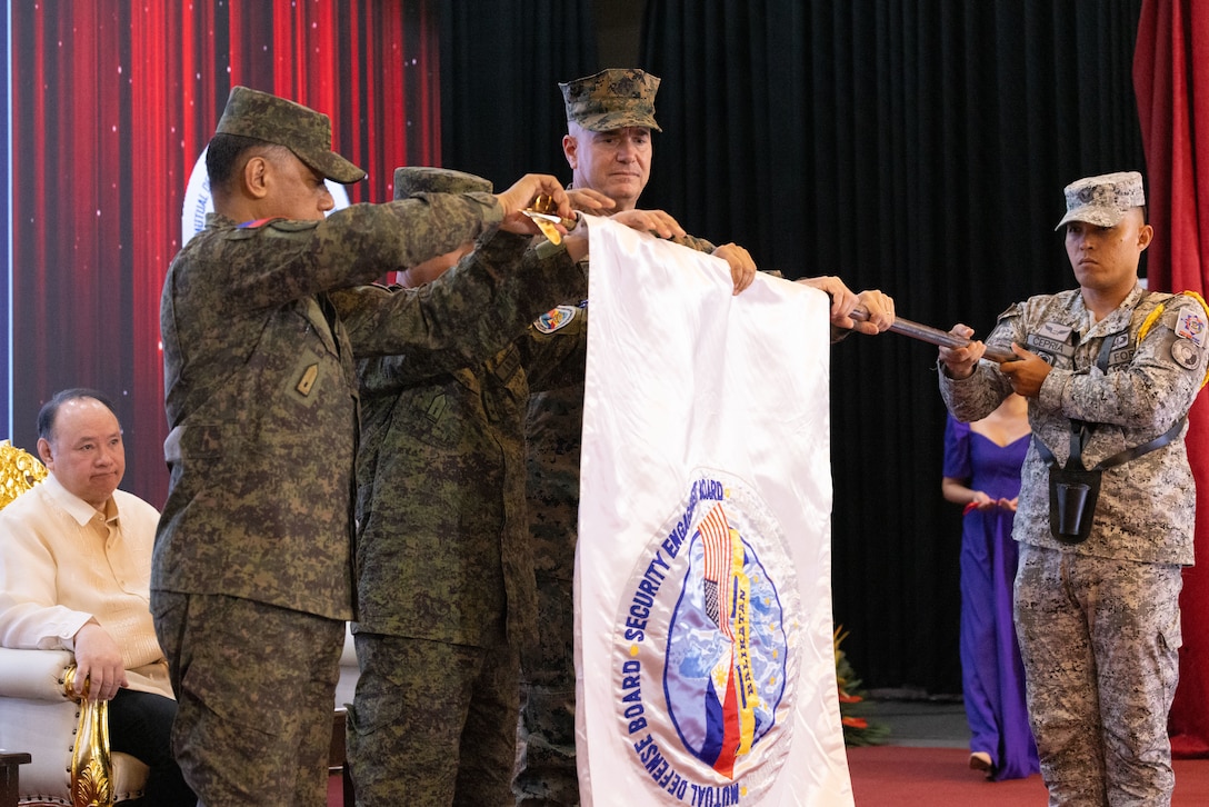 Philippine and U.S. government and military representatives furl the Balikatan flag during the closing ceremony to conclude Exercise Balikatan 25 at Camp Aguinaldo, Manila, Philippines, May 9, 2025. Balikatan is a longstanding annual exercise between the U.S. and Philippine armed forces designed to strengthen the alliance, showcase the capable combined force, and demonstrate the commitment to regional security and stability. (U.S. Marine Corps photo by Lance Cpl. Erica S. Padgett)