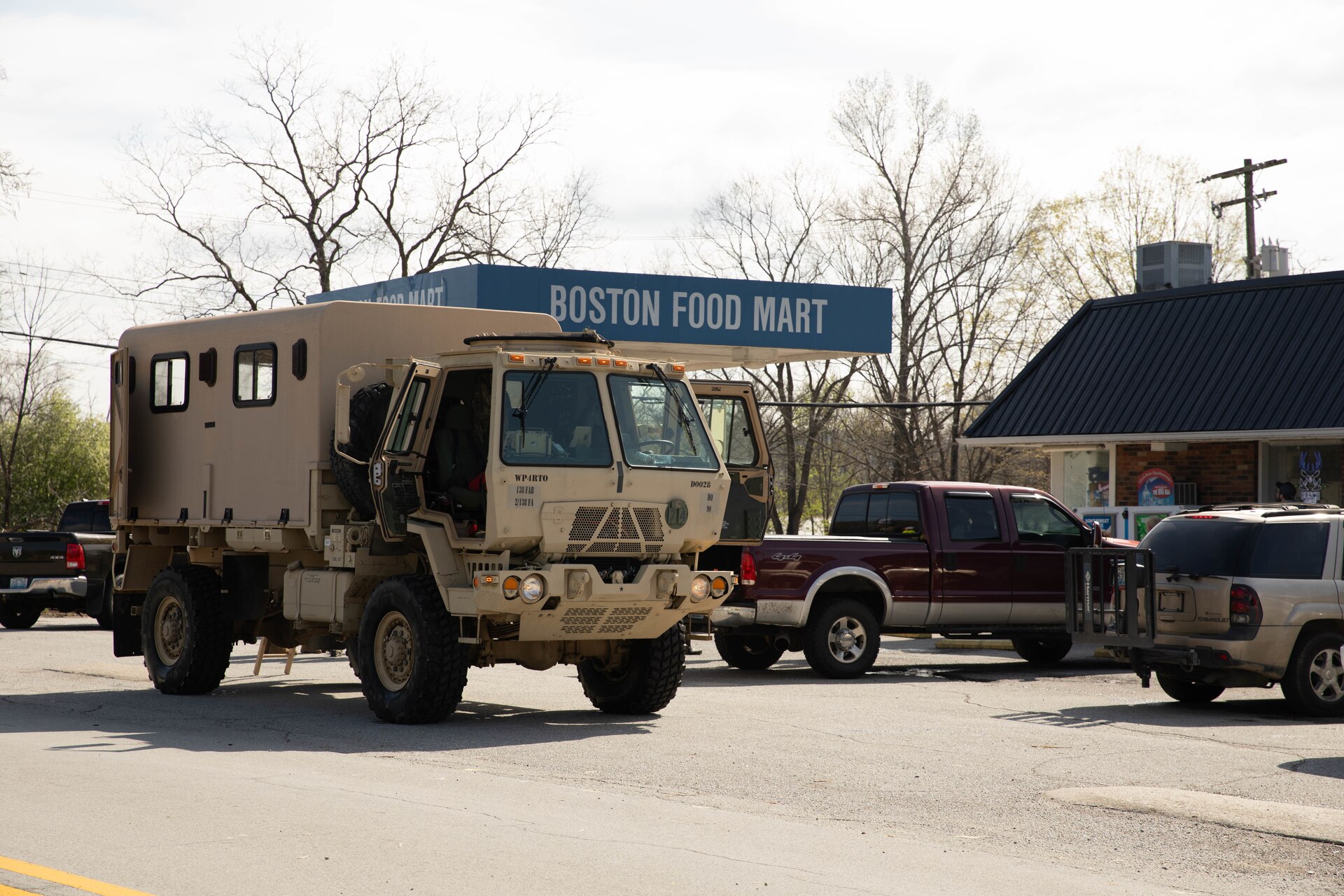 A Kentucky National Guard light medium tactical vehicle (LMTV) delivers food and other supplies to Boston, Ky., Apr. 7, 2025. Soldiers with Charlie Battery, 2nd Battalion, 138th Field Artillery Brigade based in Bardstown, work with local officials to aid Nelson Countians stranded because of flood waters. The catastrophic flooding is the result of several days of heavy rainfall across the commonwealth. (U.S. Army National Guard Photo by Milt Spalding)