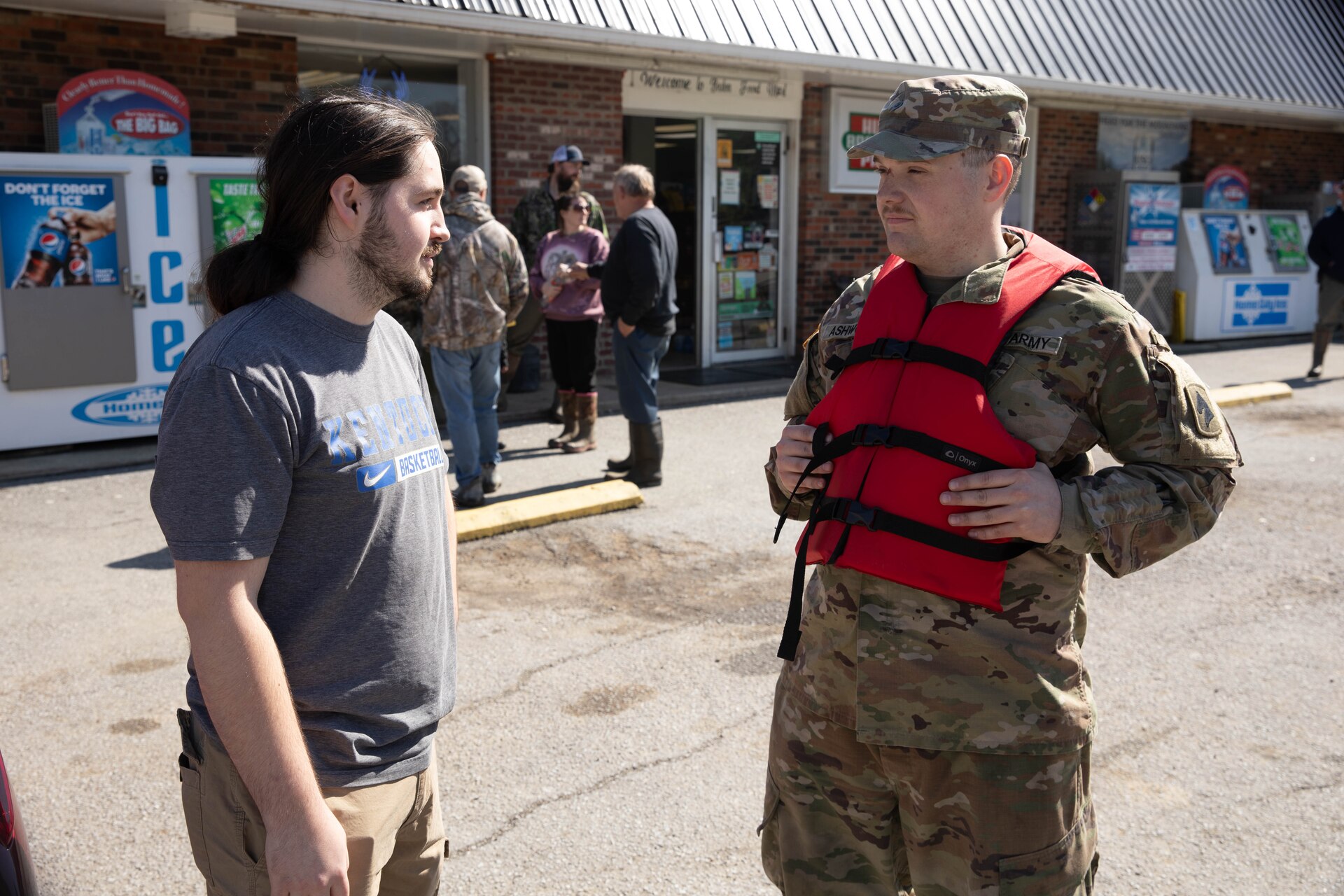 Spc. Nathan Ashworth talks with Boston, Ky. resident Collin Williamson, Apr. 7, 2025. Soldiers with Charlie Battery, 2nd Battalion, 138th Field Artillery Brigade based in Bardstown, work with local officials to aid Nelson Countians stranded because of flood waters. The catastrophic flooding is the result of several days of heavy rainfall across the commonwealth. (U.S. Army National Guard Photo by Milt Spalding)