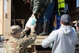 Spc. Nathan Ashworth unloads supplies to help the residents of Boston, Ky., Apr. 7, 2025. Soldiers with Charlie Battery, 2nd Battalion, 138th Field Artillery Brigade based in Bardstown, work with local officials to aid Nelson Countians stranded because of flood waters. The catastrophic flooding is the result of several days of heavy rainfall across the commonwealth. (U.S. Army National Guard Photo by Milt Spalding)