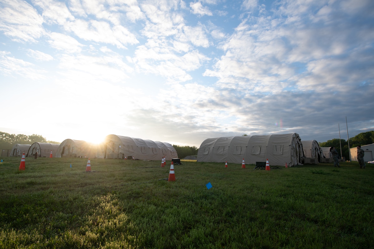 The sun rises over Base X, the simulated deployed base for Exercise Lethal Stack at McConnell Air Force Base, Kansas, May 8, 2025. Lethal Stack was a training exercise spanning five days, simulating deployment in the Indo-pacific region. (U.S. Air Force photo by Senior Airman Amelio Brown)