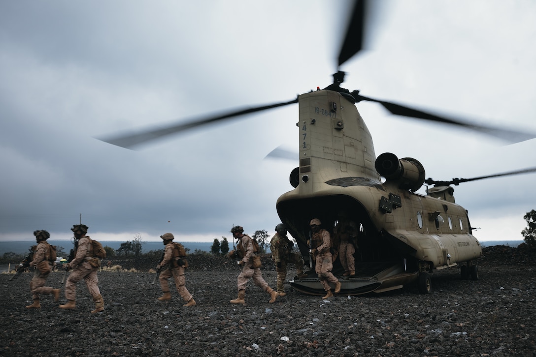 U.S. Marines with 3d Littoral Combat Team, 3d Marine Littoral Regiment, 3d Marine Division, exit a U.S. Army CH-47 Chinook during a training exercise at Pohakuloa Training Area, Hawaii, Feb. 5, 2025. As part of the exercise, 3d LCT conducted a company-level combined arms attack, enhancing the unit’s overall combat capabilities. The training exercise taking place at PTA mirrors a Service Level Training Exercise by setting conditions for 3d MLR and its subordinate battalions to go forward to the Philippines in support of Exercise Balikatan 25 and Kamandag 9 this summer. (U.S. Marine Corps photo by Sgt. Jacqueline C. Parsons)