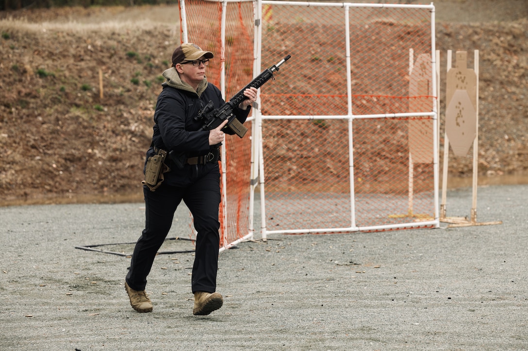 U.S. Marine Corps retired Master Sgt. Julia Watson-Carlson, a former member of the Marine Corps Shooting Team, sprints an obstacle as a part of the multi-weapon match during the Marine Corps Championships hosted by Weapons Training Battalion, on Marine Corps Base Quantico, Virginia, April 12, 2025. This competition brings together top shooters from regional marksmanship events to test their skills in precision rifle, action rifle, action pistol, and multi-gun action shooting. It continues the legacy of the Marine Corps Shooting Team, which has upheld marksmanship excellence since the early 1900s and reinforces the Corps' commitment to marksmanship as a core warfighting skill. (U.S. Marine Corps photo by Cpl. Joshua Barker)