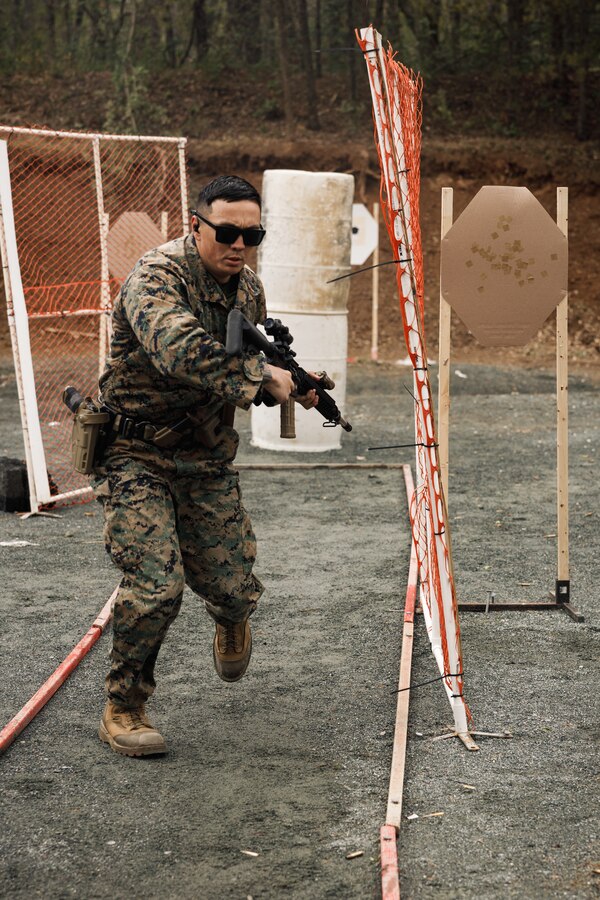 U.S. Marine Corps Gunnery Sgt. Cody Rader, a Marine Combat Instructor with the School of Infantry West, sprints to an obstacle as a part of the multi-weapon match during the Marine Corps Championships hosted by Weapons Training Battalion, on Marine Corps Base Quantico, Virginia, April 12, 2025. This competition brings together top shooters from regional marksmanship events to test their skills in precision rifle, action rifle, action pistol, and multi-gun action shooting. It continues the legacy of the Marine Corps Shooting Team, which has upheld marksmanship excellence since the early 1900s and reinforces the Corps' commitment to marksmanship as a core warfighting skill. (U.S. Marine Corps photo by Cpl. Joshua Barker)