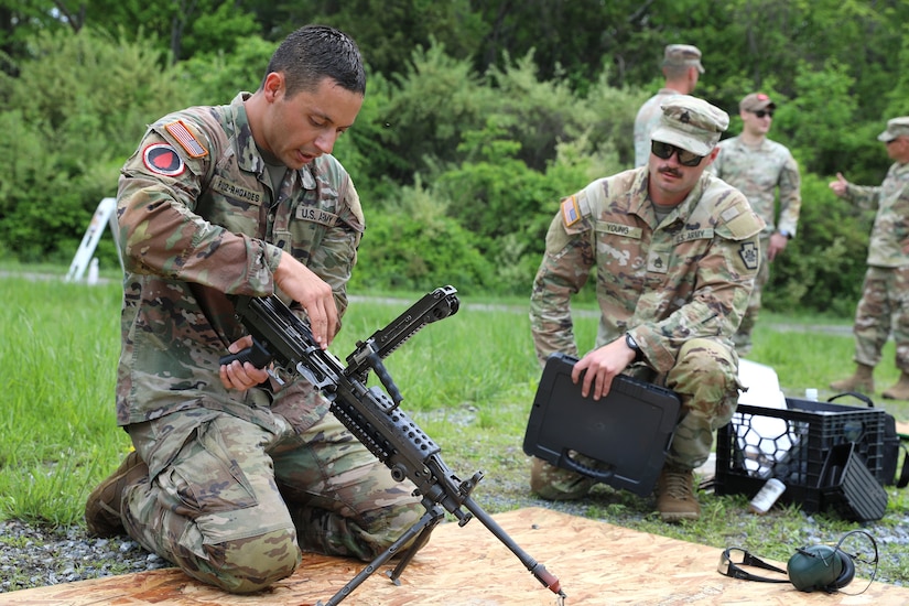 Spc. Robert Ruiz-Rhoades of the Pennsylvania National Guard's 28th Expeditionary Combat Aviation Brigade assembles an M249 light machine gun during the Region II Best Warrior Competition at Fort Indiantown Gap, Pennsylvania, May 8, 2025. (U.S. Army National Guard photo by Spc. Annie M. Riley)