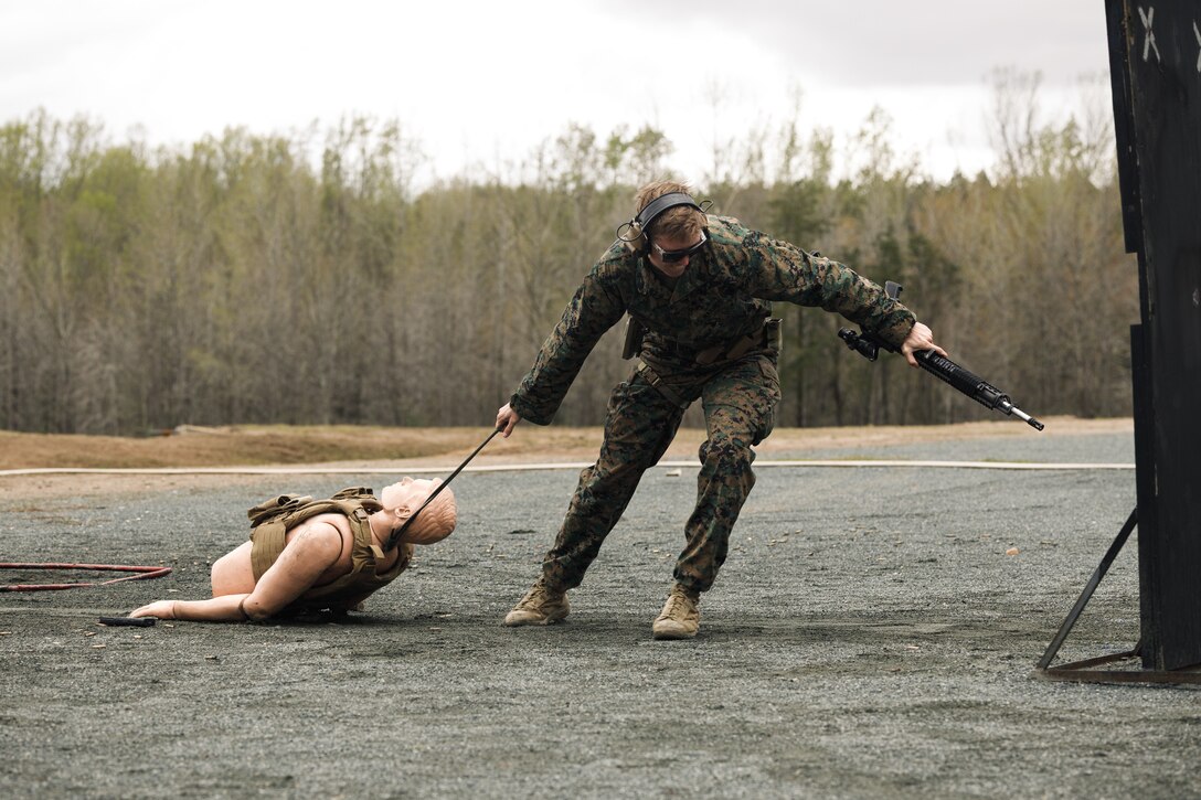 U.S. Marine Corps Sgt. Lane Shierling, a marksmanship instructor with 1st Maintenance Battalion, 1st Combat Readiness Regiment, 1st Marine Logistics Group, drags a simulated casualty as a part of the multi-weapon match during the Marine Corps Championships hosted by Weapons Training Battalion, on Marine Corps Base Quantico, Virginia, April 12, 2025. This competition brings together top shooters from regional marksmanship events to test their skills in precision rifle, action rifle, action pistol, and multi-gun action shooting. It continues the legacy of the Marine Corps Shooting Team, which has upheld marksmanship excellence since the early 1900s and reinforces the Corps' commitment to marksmanship as a core warfighting skill. (U.S. Marine Corps photo by Cpl. Joshua Barker)
