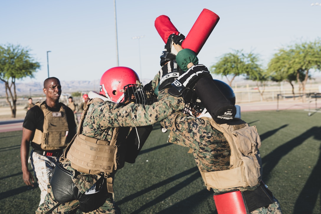 Students with Marine Corps Martial Arts Instructor Course 73-25 strike each other during a pugil stick fighting event at Marine Corps Air Ground Combat Center, Twentynine Palms, California, April 29, 2025. The MCMAIC certifies Marines to instruct and monitor Marine Corps Martial Arts Program training and advance Marines in the program while testing and strengthening their decision making, warfighting, and leadership skills. (U.S. Marine Corps photo by Cpl. Damian Oso)