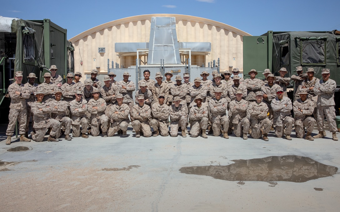U.S. Marine food service specialists attached to Marine Air-Ground Task Force 23, pose for a group photo during Integrated Training Exercise 4-24, Marine Air-Ground Combat Center, Twentynine Palms, California, June 26, 2024. The food service specialists feed up to 4,729 Marine reservists daily, providing required nutrients for operations during ITX 4-24. Reserve Marines and Sailors have come together from across the nation to form an integrated Marine Air-Ground Task Force to take part in a live-fire, combined arms exercise that will better prepare Marine Forces Reserve in its mission to augment and reinforce the active component. (U.S. Marine Corps photo by Orion Stpierre)