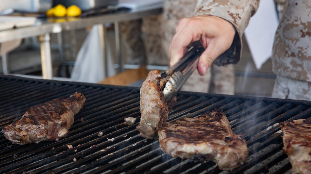 U.S. Marine Corps Gunnery Sgt. Taylor J. Dagostino, mess management chief, Headquarters Company, 23rd Marine Regiment, 4th Marine Division, prepares food for the warrior meal at Integrated Training Exercise 4-24, Marine Corps Air-Ground Combat Center, Twentynine Palms, California, June 23, 2024. Active and reserve component integration is vital to sharing knowledge and demonstrating how the two support each other. Reserve Marines and Sailors have come together from across the nation to form an integrated Marine Air-Ground Task Force to take part in a live-fire, combined arms exercise that will better prepare Marine Forces Reserve in its mission to augment and reinforce the active component.  (U.S. Marine Corps photo by Orion Stpierre)