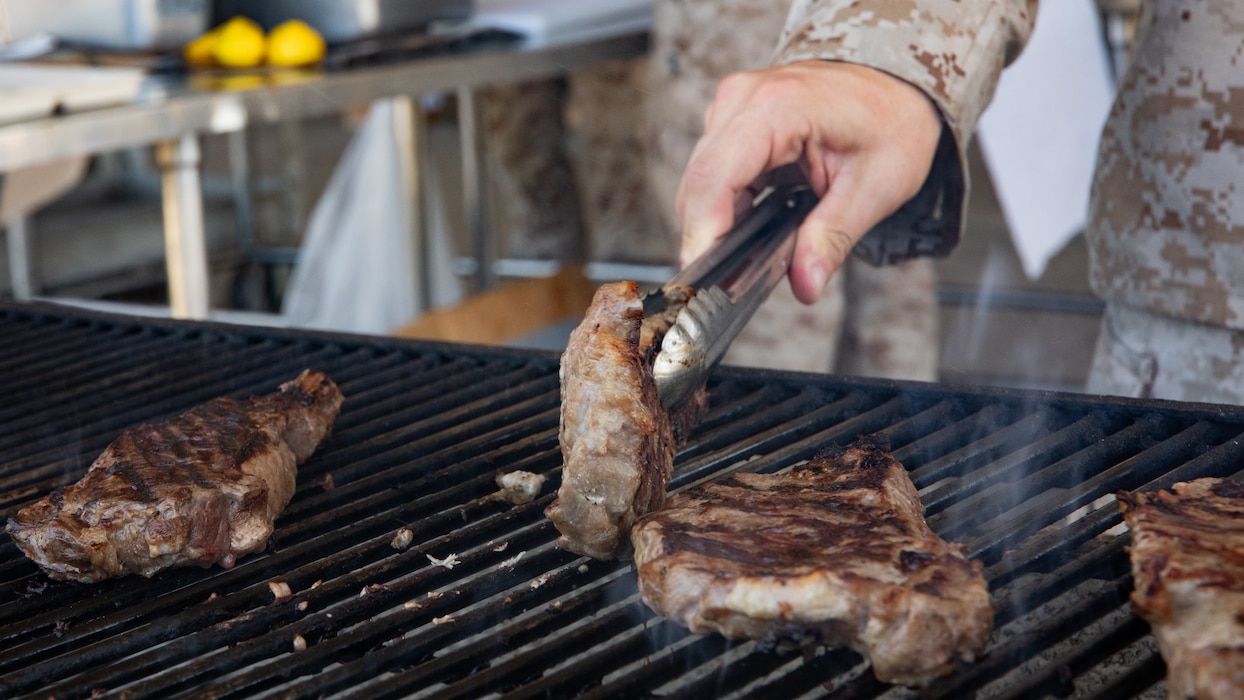 U.S. Marine Corps Gunnery Sgt. Taylor J. Dagostino, mess management chief, Headquarters Company, 23rd Marine Regiment, 4th Marine Division, prepares food for the warrior meal at Integrated Training Exercise 4-24, Marine Corps Air-Ground Combat Center, Twentynine Palms, California, June 23, 2024. Active and reserve component integration is vital to sharing knowledge and demonstrating how the two support each other. Reserve Marines and Sailors have come together from across the nation to form an integrated Marine Air-Ground Task Force to take part in a live-fire, combined arms exercise that will better prepare Marine Forces Reserve in its mission to augment and reinforce the active component.  (U.S. Marine Corps photo by Orion Stpierre)