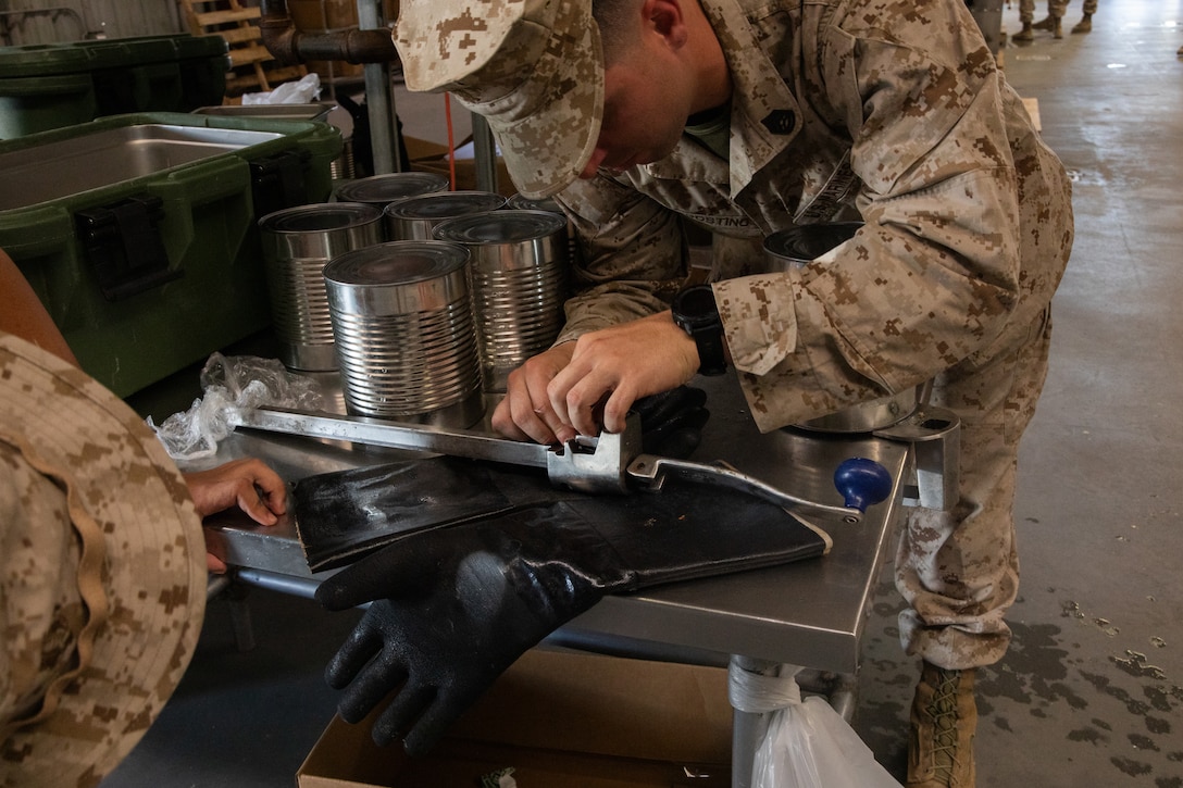 U.S. Marine Corps Gunnery Sgt. Taylor J. Dagostino, mess management chief, Headquarters Company, 23rd Marine Regiment, 4th Marine Division, repairs a can opener to continue preparing the warriors meal at Integrated Training Exercise 4-24, Marine Corps Air-Ground Combat Center, Twentynine Palms, California, June 23, 2024. Active and reserve component integration is vital to sharing knowledge and demonstrating how the two support each other. Reserve Marines and Sailors have come together from across the nation to form an integrated Marine Air-Ground Task Force to take part in a live-fire, combined arms exercise that will better prepare Marine Forces Reserve in its mission to augment and reinforce the active component. (U.S. Marine Corps photo by Orion Stpierre)