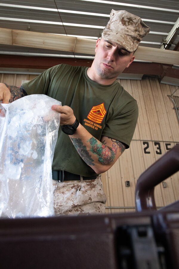 U.S. Marine Corps Gunnery Sgt. Taylor J. Dagostino, mess management chief, Headquarters Company, 23rd Marine Regiment, 4th Marine Division, prepares food for the warrior meal at Integrated Training Exercise 4-24, Marine Corps Air-Ground Combat Center, Twentynine Palms, California, June 23, 2024. Active and reserve component integration is vital to sharing knowledge and demonstrating how the two support each other. Reserve Marines and Sailors have come together from across the nation to form an integrated Marine Air-Ground Task Force to take part in a live-fire, combined arms exercise that will better prepare Marine Forces Reserve in its mission to augment and reinforce the active component. (U.S. Marine Corps photo by Orion Stpierre)