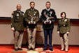 Spc. Robert Ruiz-Rhoades, second from left, of the Pennsylvania National Guard and Sgt. Miles Crawford, third from left, of the Maryland National Guard were named the winners of the Region II Best Warrior Competition during a ceremony May 9, 2025, at Fort Indiantown Gap, Pa. They were recognized by Command Sgt. Maj. Shawn Phillips, left, command senior enlisted leader, Pennsylvania National Guard, and Maj. Gen. Laura McHugh, right, deputy adjutant general - Army, Pennsylvania National Guard. (U.S. Army National Guard photo by Spc. Skylin Simpson)
