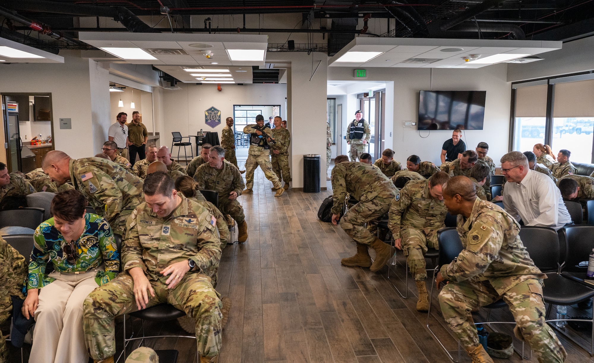 Military members take cover during an active shooter exercise.