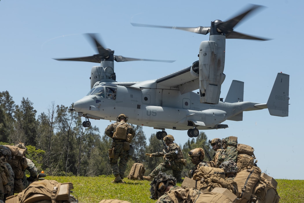 U.S. Marines with Animal Company, Battalion Landing Team 1st Battalion, 7th Marine Regiment, 31st Marine Expeditionary Unit, prepare to embark an MV-22B Osprey aircraft assigned to Marine Medium Tilt Rotor Squadron 265 (Rein.) during a quick response force rehearsal as a part of MEU Exercise, at Camp Hansen, Okinawa, Japan, May 3, 2025.