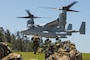 U.S. Marines with Animal Company, Battalion Landing Team 1st Battalion, 7th Marine Regiment, 31st Marine Expeditionary Unit, prepare to embark an MV-22B Osprey aircraft assigned to Marine Medium Tilt Rotor Squadron 265 (Rein.) during a quick response force rehearsal as a part of MEU Exercise, at Camp Hansen, Okinawa, Japan, May 3, 2025.