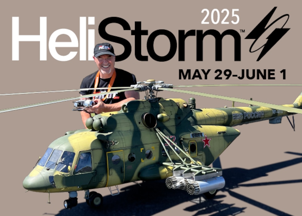 HeliStorm logo with a man kneeling next to a large model RC helicopter that is painted green.