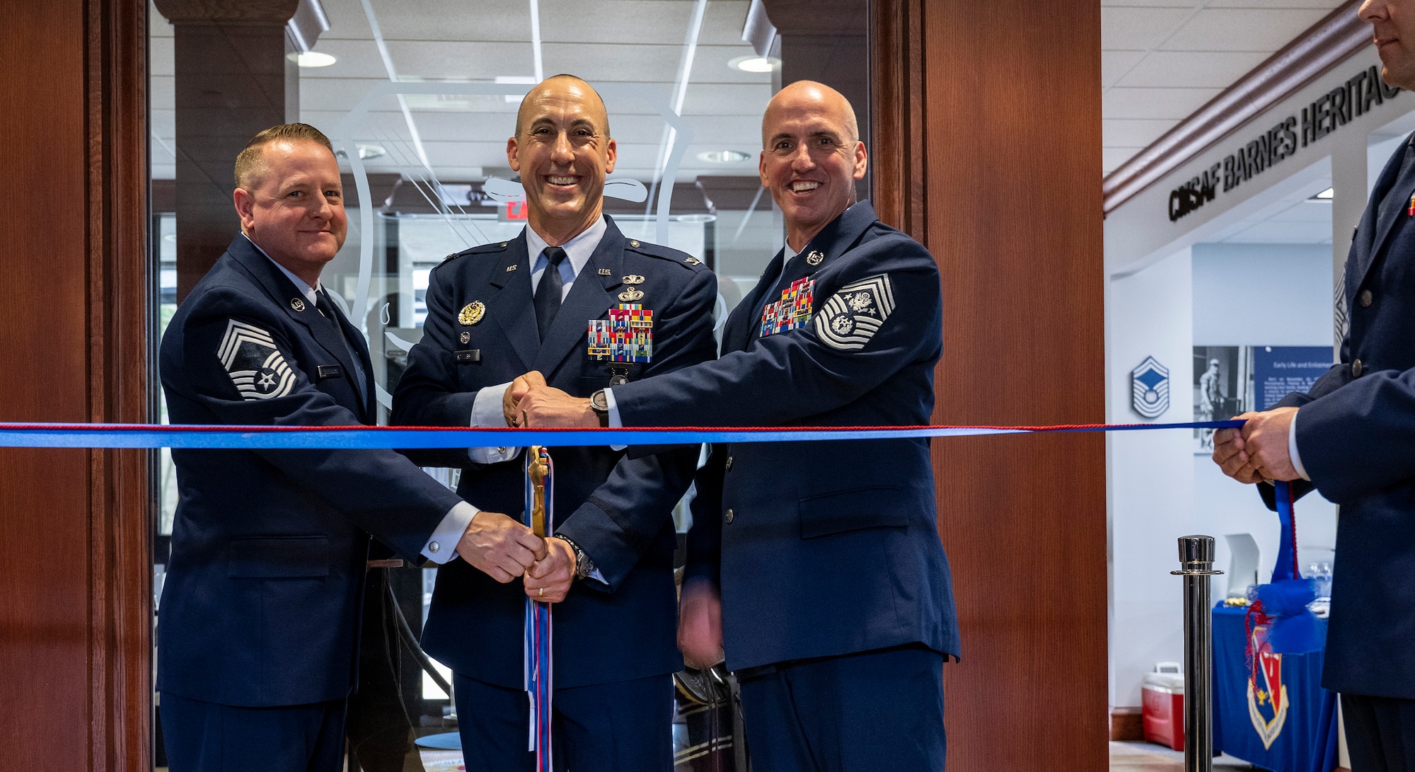 Left to right, Chief Master Sgt. Sean Ellenburg, Col. Damian Schlussel and Chief Master Sgt. of the Air Force Davis A. Flosi cut the ribbon on the new Thomas N. Barnes Center for Enlisted Education during the Barnes Center’s ribbon cutting ceremony on Maxwell Air Force Base, Ala., May 9, 2025. The center moved from Gunter Annex to Chennault Circle, the heart of Air University’s campus, historically known for officer education and training. Ellenburg is the senior enlisted leader of the Barnes Center and Schlussel is the commander. (U.S. Air Force photo/Brian Ferguson)