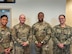 Four recruiters standing together at a recruiting station.