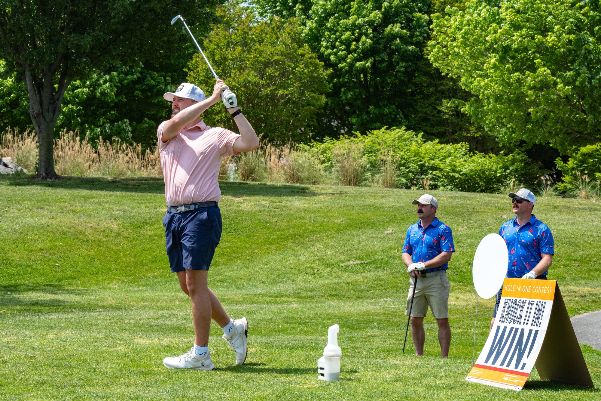 A participant of the 2025 Bluesuiters Golf Tournament swings at a ball at Jonathan’s Landing Golf Course in Magnolia, Delaware, May 8, 2025. Bluesuiters is a biannual golf tournament that teams up Dover Air Force Base Airmen and local civic leaders to network and build partnerships. (U.S. Air Force photo by Senior Airman Trenten Walters)