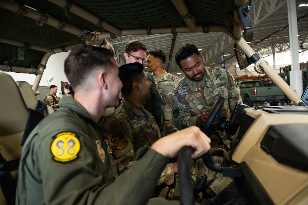 Airman explains vehicle controls to cadets.