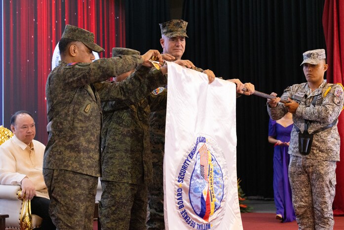 Philippine and U.S. government and military representatives furl the Balikatan flag during the closing ceremony to conclude Exercise Balikatan 25 at Camp Aguinaldo, Manila, Philippines, May 9, 2025. Balikatan is a longstanding annual exercise between the U.S. and Philippine armed forces designed to strengthen the alliance, showcase the capable combined force, and demonstrate the commitment to regional security and stability. (U.S. Marine Corps photo by Lance Cpl. Erica S. Padgett)