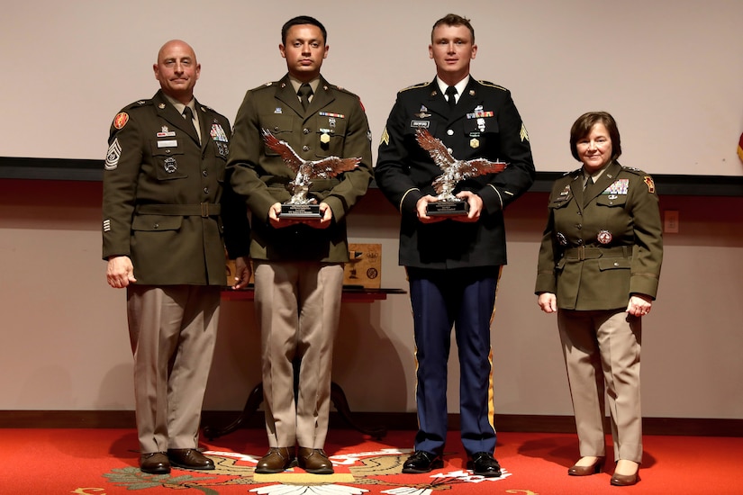 Spc. Robert Ruiz-Rhoades, second from left, of the Pennsylvania National Guard and Sgt. Miles Crawford, third from left, of the Maryland National Guard were named the winners of the Region II Best Warrior Competition during a ceremony May 9, 2025, at Fort Indiantown Gap, Pa. They were recognized by Command Sgt. Maj. Shawn Phillips, left, command senior enlisted leader, Pennsylvania National Guard, and Maj. Gen. Laura McHugh, right, deputy adjutant general - Army, Pennsylvania National Guard. (U.S. Army National Guard photo by Spc. Skylin Simpson)