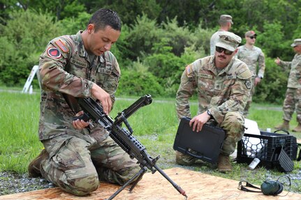 Spc. Robert Ruiz-Rhoades of the Pennsylvania National Guard's 28th Expeditionary Combat Aviation Brigade assembles an M249 light machine gun during the Region II Best Warrior Competition at Fort Indiantown Gap, Pennsylvania, May 8, 2025. (U.S. Army National Guard photo by Spc. Annie M. Riley)
