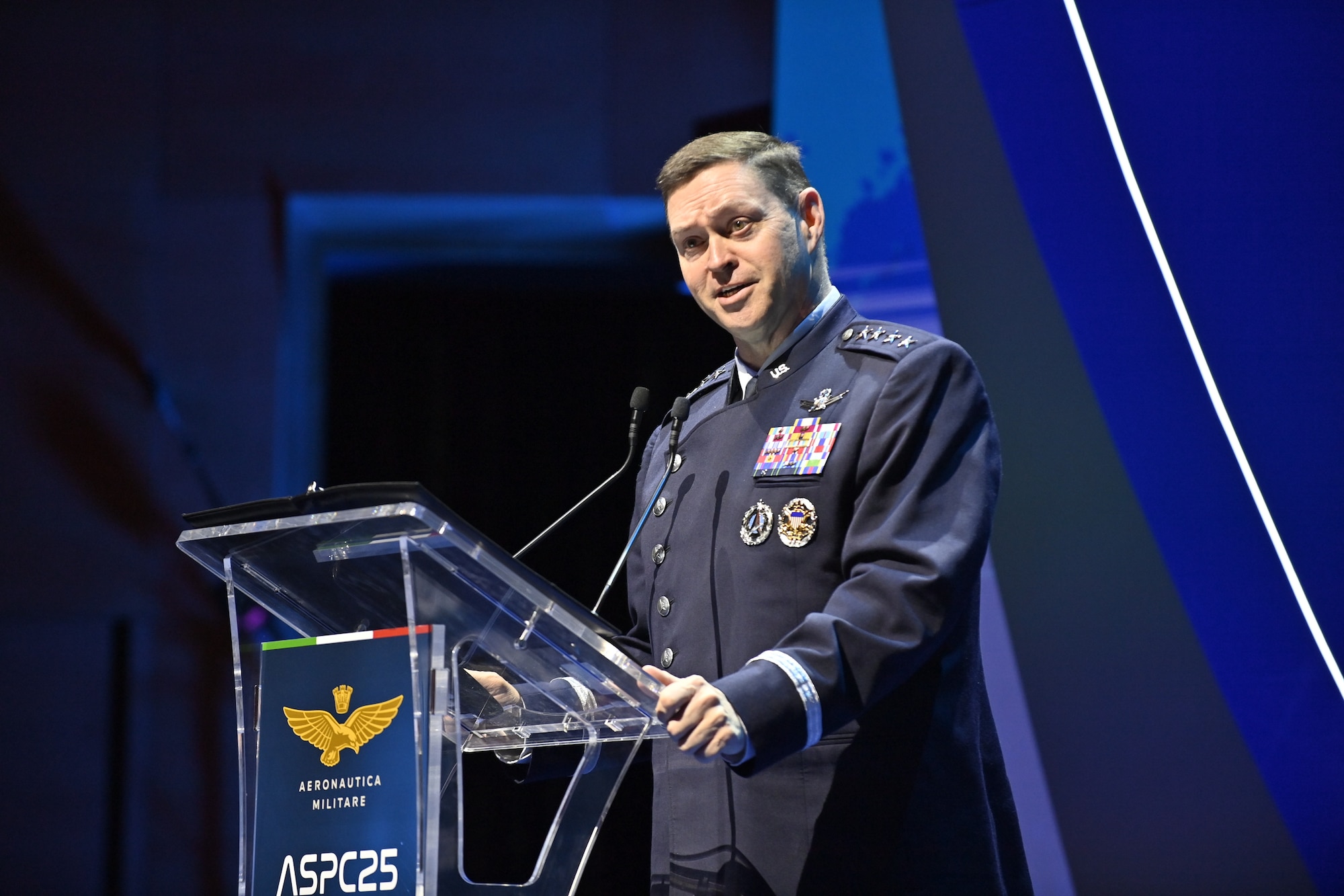 A military member speaks at a podium.