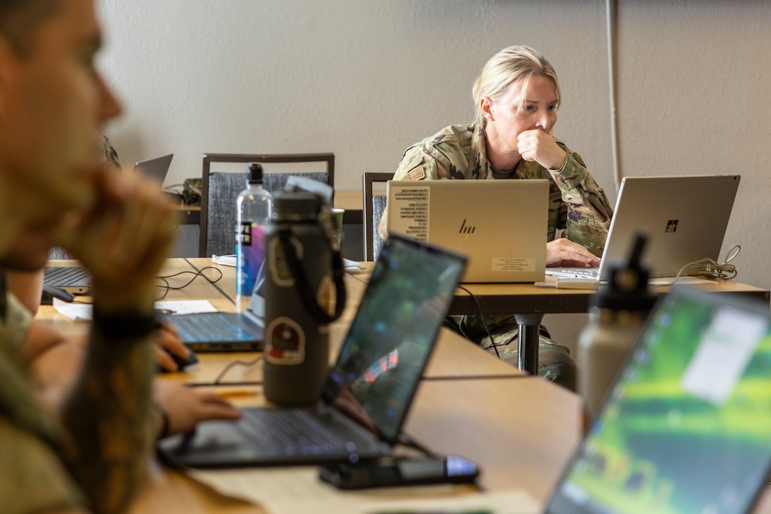 U.S. Air Force Chief Master Sgt. Jessica Cusson, senior enlisted leader, 114th Electromagnetic Warfare Squadron, Florida Air National Guard, conducts defensive cyber operations during exercise Southern Defender 25 in Augusta, Georgia, May 6, 2025.  SD 25 is a defensive cyberspace operations focused exercise designed for the U.S. and Allies and partners to collectively strengthen cyberspace awareness, exercise joint all domain operations and counter harmful actors while building multi-lateral capacity. (U.S. Marine Corps photo by Sgt. Samuel Qin)