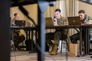U.S. Army Lt. Col. Brian Weiblinger, left, team chief, Defense of Cyber Operations Element Team, Florida Army National Guard, and U.S. Marine Corps Sgt. Thane Murphy, center, intelligence analyst, and Sgt. Victor Navarro, right, cyber warfare operator, Defensive Cyberspace Operations Internal Defensive Measures, conduct defensive cyber operations during exercise Southern Defender 25 in Augusta, Georgia, May 6, 2025. This exercise pushes teams to identify vulnerabilities, respond to adversary injects, and coordinate actions across 28 teams in 15 locations consisting of 20 participating countries in real time. (U.S. Marine Corps photo by Sgt. Samuel Qin)