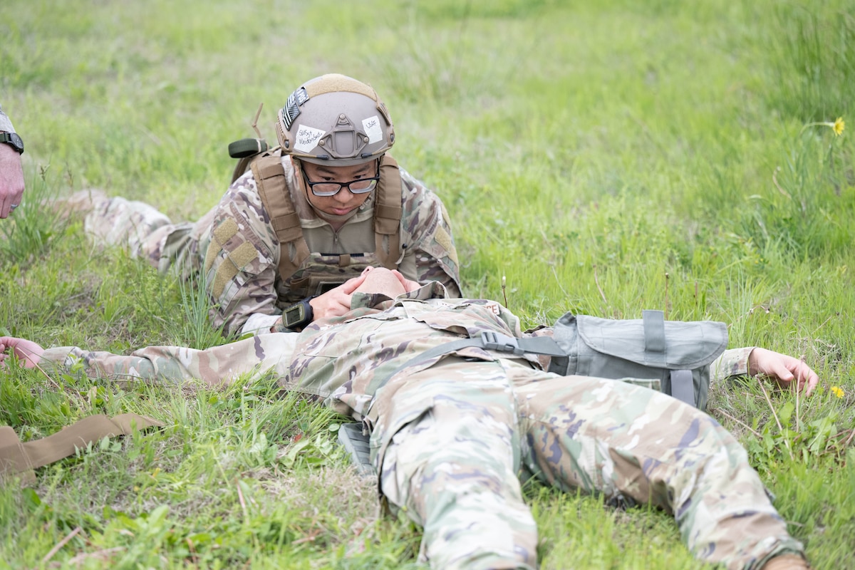 Senior Master Sgt. Joseph Weidenbach, 22nd Maintenance Squadron first sergeant, performs Tactical Combat Casualty Care on a simulated downed airman during exercise Lethal Stack at McConnell Air Force Base, Kansas, May 6, 2025. The weeklong exercise tested units’ ability to generate aircraft and operate within a contested environment to increase lethality, survivability and agility. (U.S. Air Force photo by Senior Airman Felicia Przydzial)