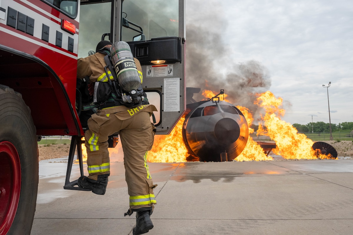 Staff Sgt. Logan Bruno, 22nd Civil Engineer Squadron firefighter, steps out of a fire truck during Exercise Lethal Stack at McConnell Air Force Base, Kansas, May 6, 2025.  McConnell Airmen are mission ready, capable and resilient against any known or emerging threat. (U.S. Air Force photo by Airman 1st Class Patrick O’Neill)