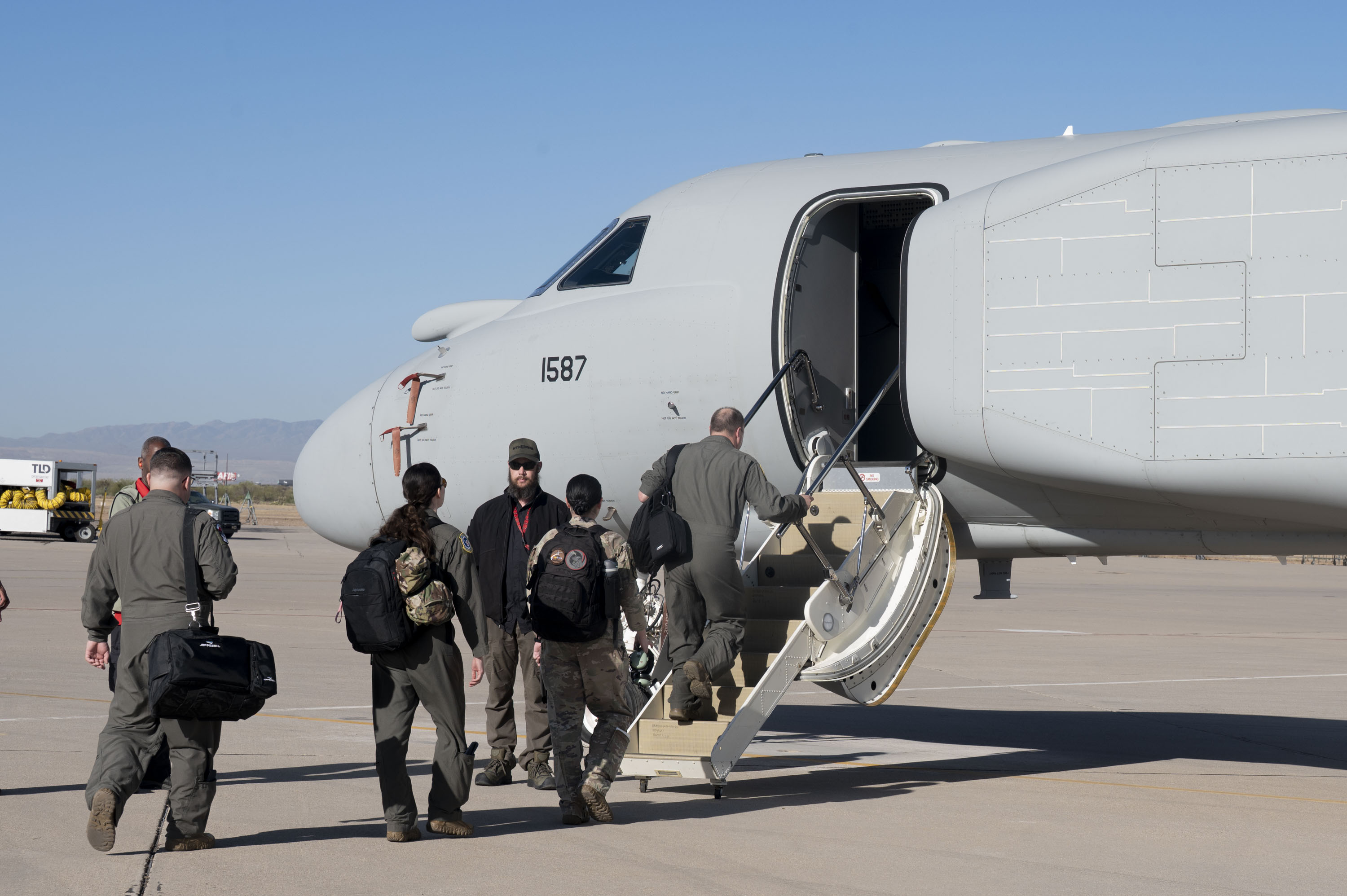 U.S. Air Force Airmen assigned to the 43rd Electronic Combat Squadron board an EA-37B Compass Call aircraft before it takes off for its first official mission training sortie flight at Davis-Monthan Air Force Base, Arizona, May 2, 2025. The aircraft consists of classified modifications to the mission system that enhance precision and increase target capacity. (U.S. Air Force photo by Airman Samantha Melecio)