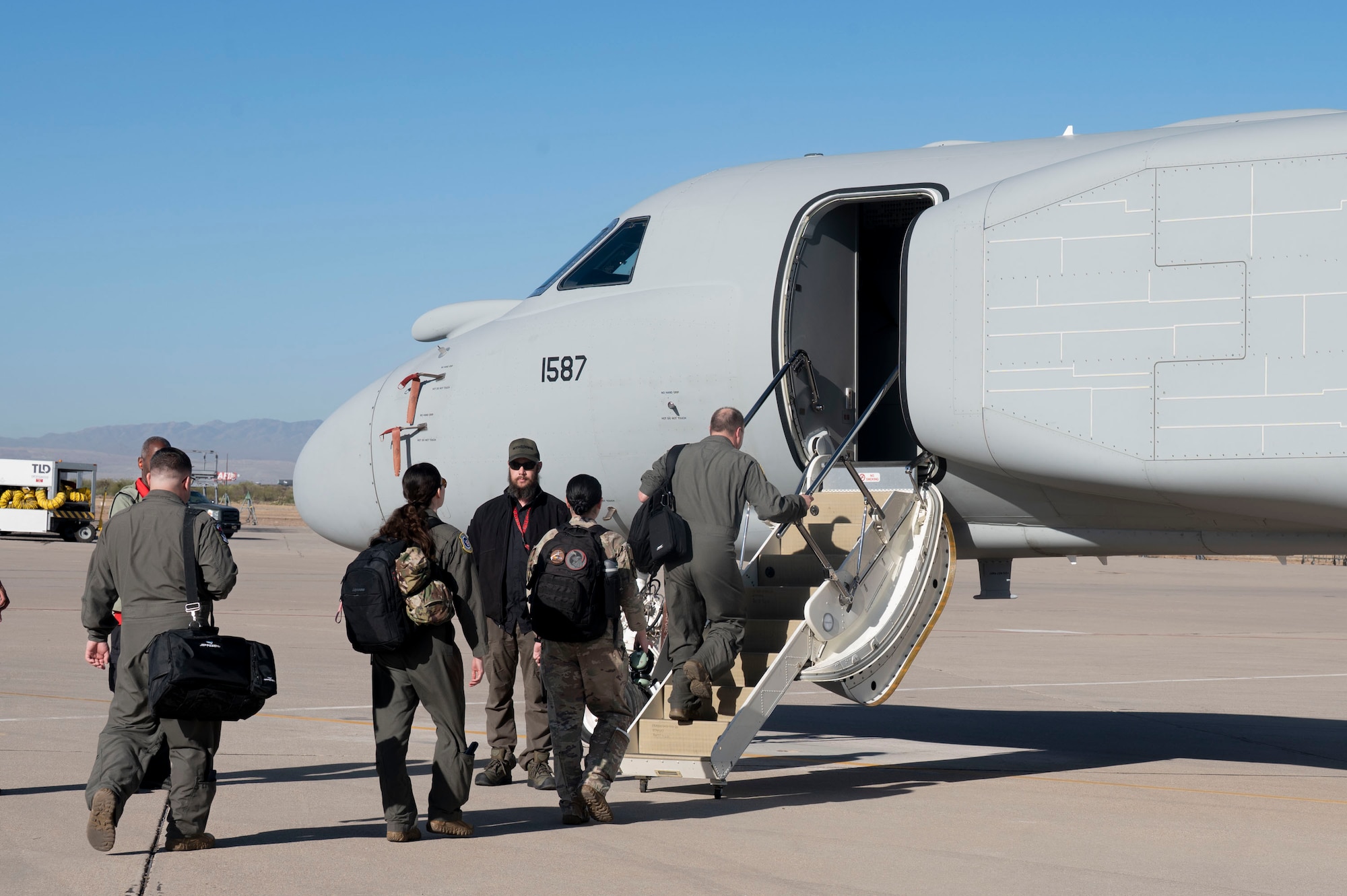 U.S. Air Force Airmen assigned to the 43rd Electronic Combat Squadron board an EA-37B Compass Call aircraft before it takes off for its first official mission training sortie flight at Davis-Monthan Air Force Base, Arizona, May 2, 2025. The aircraft consists of classified modifications to the mission system that enhance precision and increase target capacity. (U.S. Air Force photo by Airman Samantha Melecio)