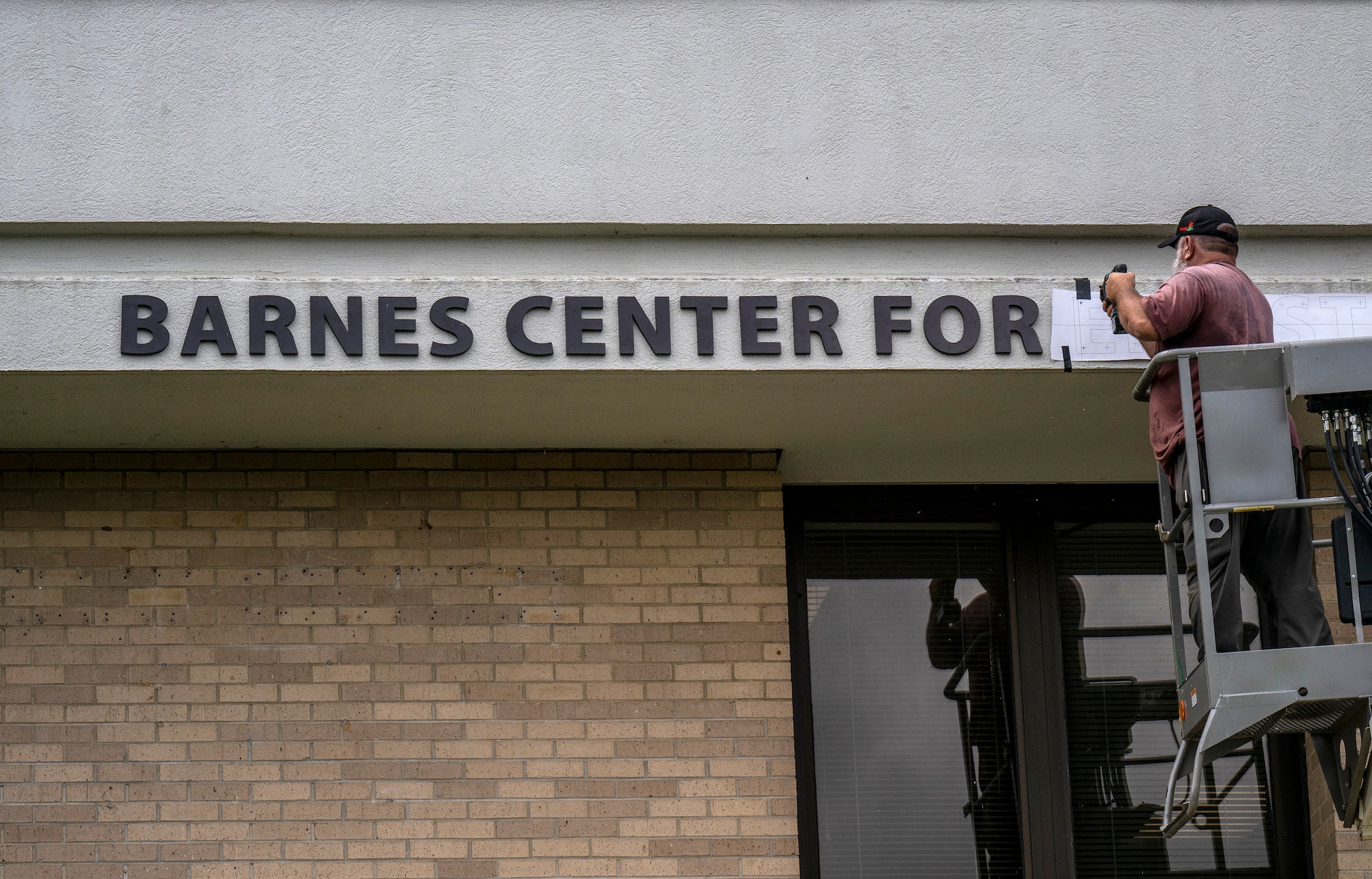 A contractor installs the sign on the new Thomas N. Barnes Center for Enlisted Education, building 1400, on Maxwell Air Force Base, Ala., May 2, 2025. (U.S. Air Force photo/Brian Ferguson)