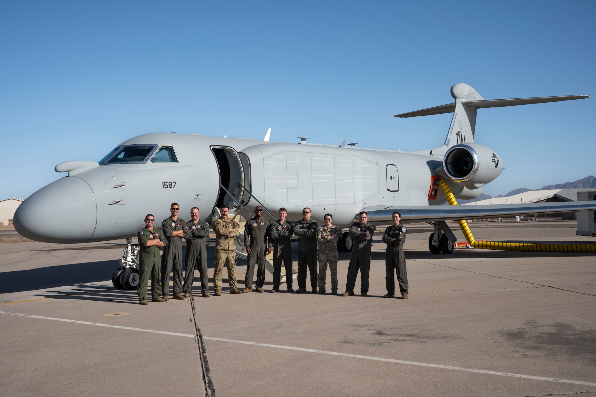 U.S. Airmen assigned to the 43rd Electronic Combat Squadron pose for a group photo before boarding the EA-37B Compass Call aircraft for its first official mission training sortie flight at Davis-Monthan Air Force Base, Arizona, May 2, 2025. The EA-37B sustains Joint Force military advantage in the electromagnetic battlespace and builds a more lethal force by modernizing electromagnetic attack capabilities to deny peer competitors' tactical networks and information ecosystems. (U.S. Air Force photo by Airman Samantha Melecio)